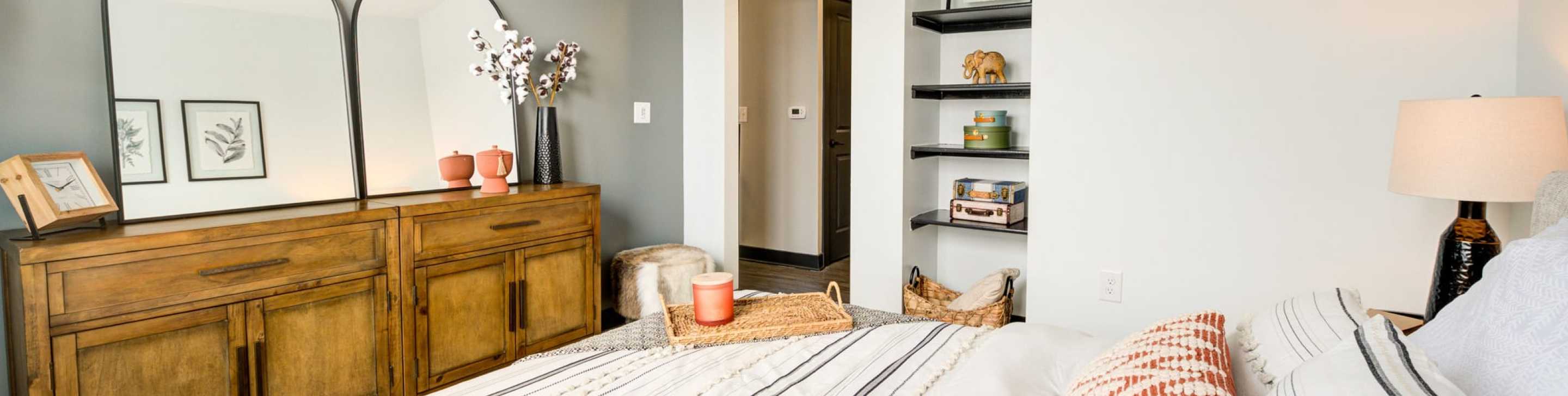 A bedroom with a dresser